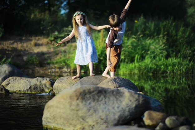 Children walk in the summer in nature Child on a sunny spring morning in the park Traveling with children