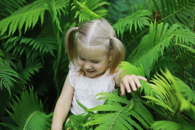 Children walk in the summer in nature child on a sunny spring morning in the park traveling with children