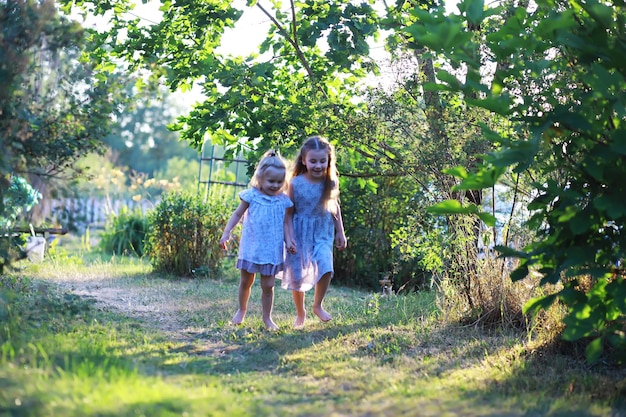 Children walk in the summer in nature Child on a sunny spring morning in the park Traveling with children