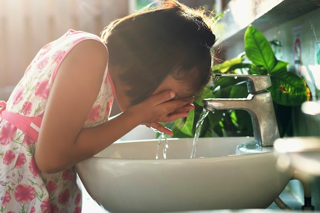 Children washing face in basin