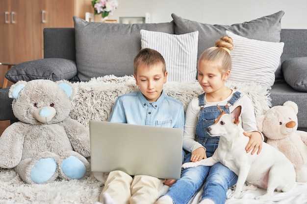 Children watching videos on laptop