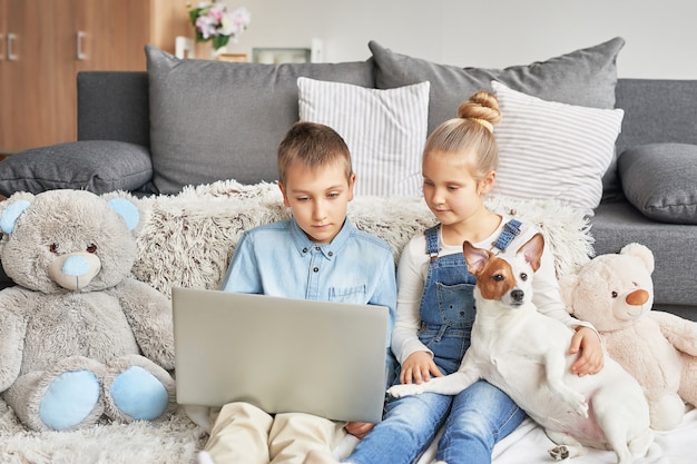 Children watching videos on laptop