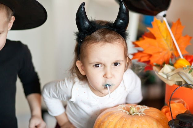 Children in witch and devil costumes for Halloween