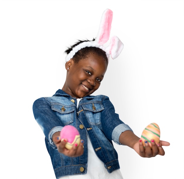 Children with bunny hairband and easter eggs