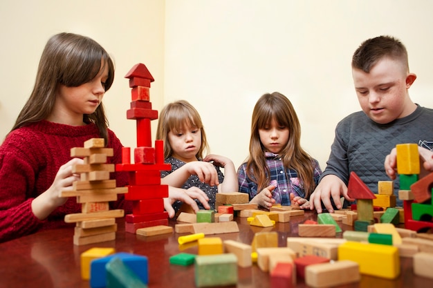 Children with down syndrome playing with blocks