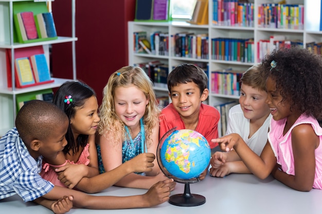 Children with globe on table