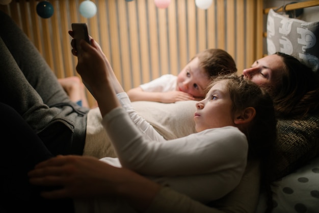 Children with mother watching a tablet pc