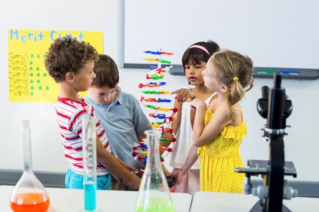 Children with scientific equipment in laboratory