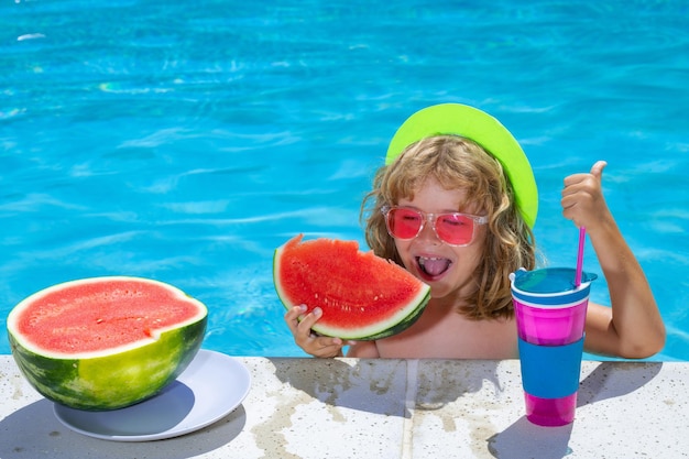 Children with watermelon playing in swimming pool Kids holidays and summer vacation concept Summer kids cocktail