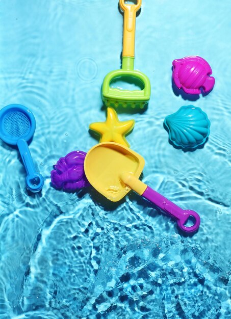 Childrens beach toys on splashing water