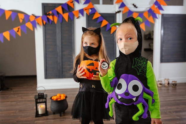 Childrens on a Halloween in costume and face masks