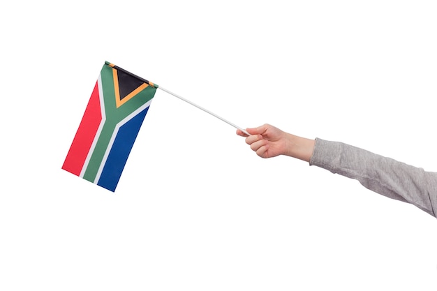 Childrens hand holds flag of South Africa isolated on white background. Mockup