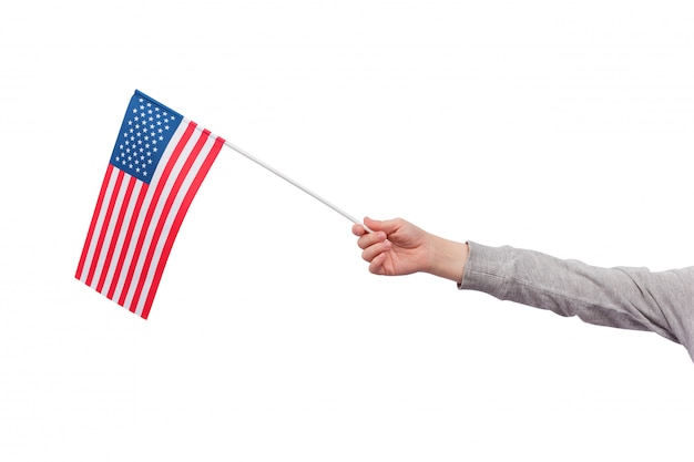 Childrens hand holds the flag of USA isolated on white space. Flag of United States of America