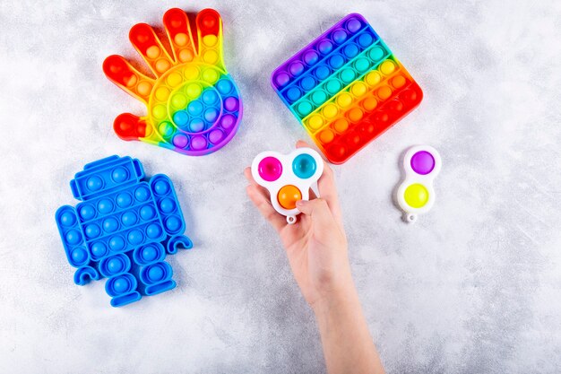 Childrens hand is playing a new trendy silicone toy antistress