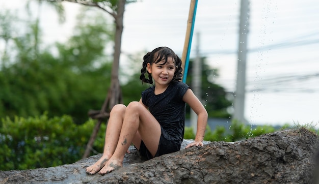 Childrens have fun playing mud slides in the community fields