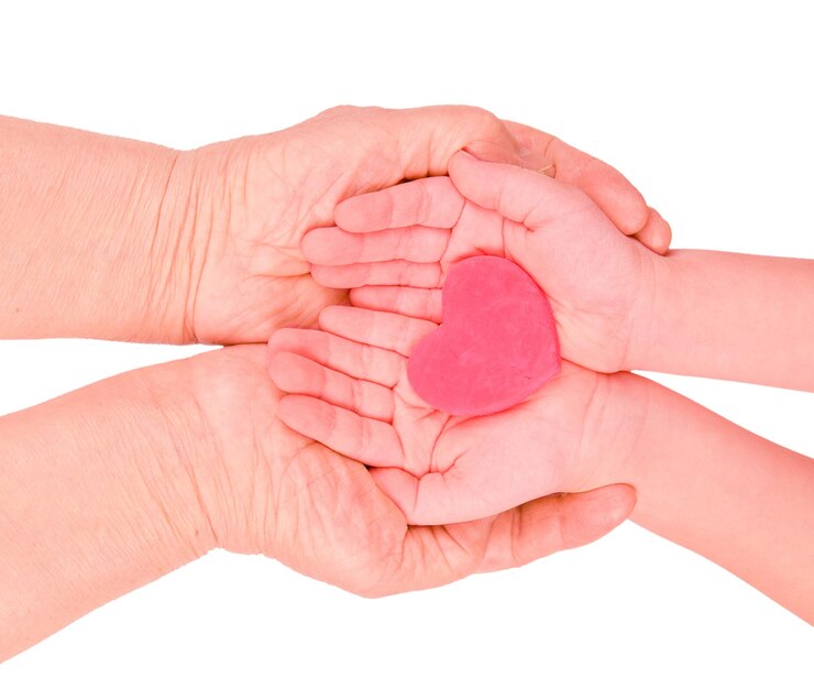 Childrens palms hold a plasticine red heart in their mothers hands Isolate on a white background