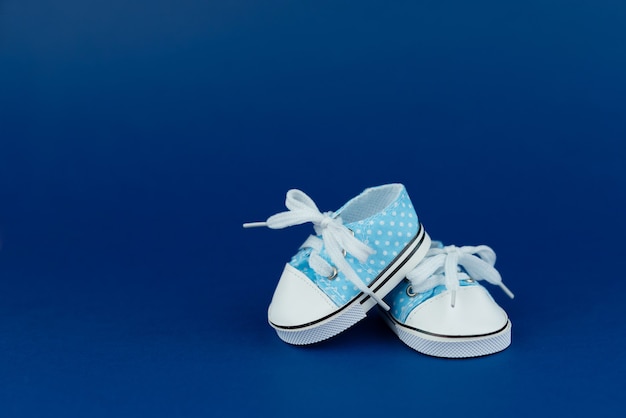 Photo childrens shoes for a boy on a blue background baby shower party