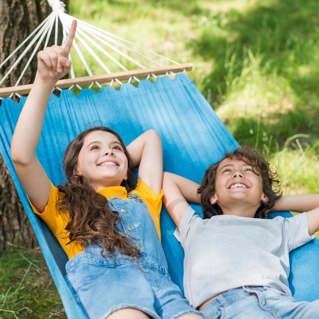 Childrens sitting in hammock