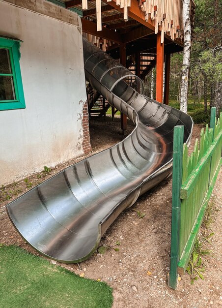 Photo childrens slide in the form of a pipe in an amusement park recreation and entertainment concept