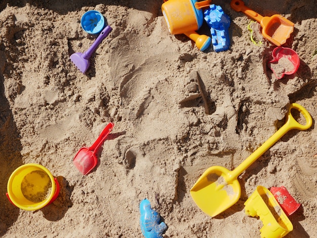 Childrens toys scattered in the sandbox