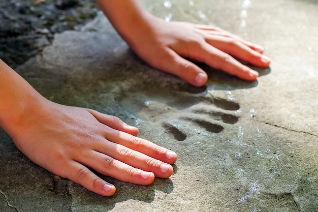 Childs hand and memorable handprint in concrete