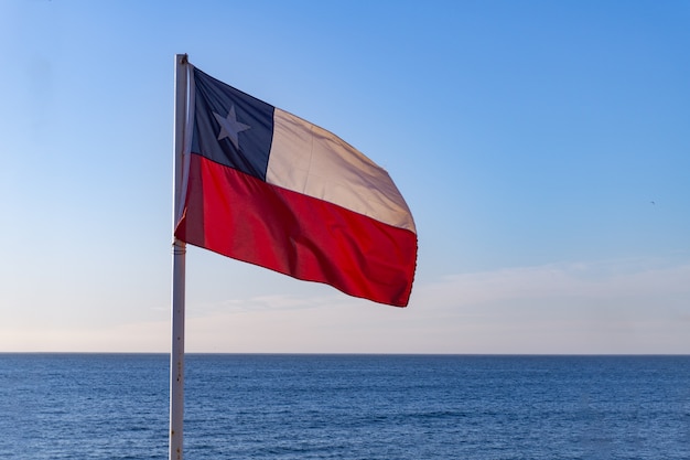 Chilean flagg with pacific ocean at behind