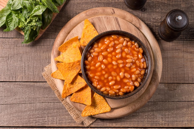 Chili beans on wooden table background. Kidney beans and vegetable Mexican food.