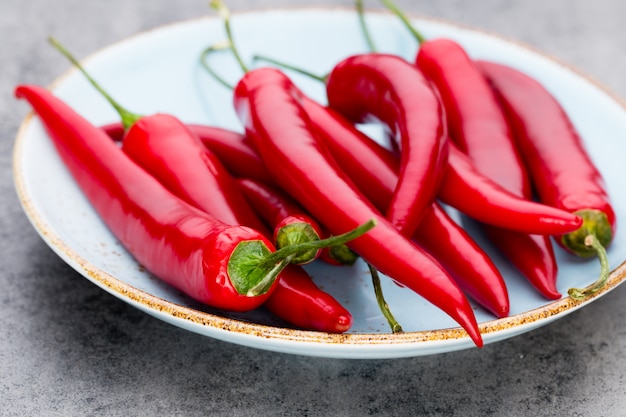 Chili cayenne pepper on grey background