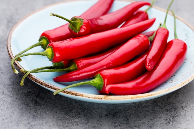 Chili cayenne pepper on grey table.