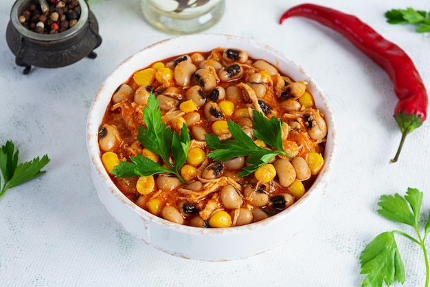 Chili con carne in a bowl Mexican cuisine Chili with meat corn and beans