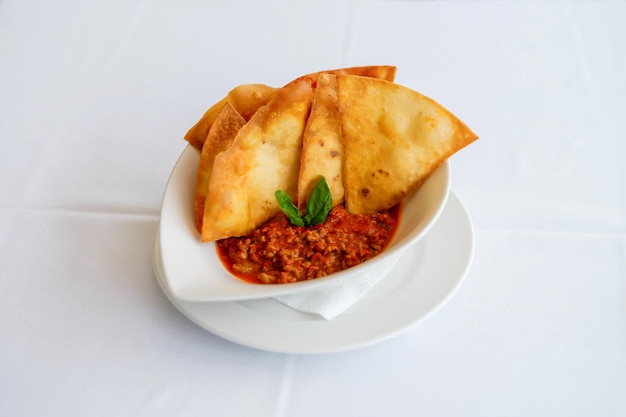 Chili con carne meat sauce with tomatoes and chili with tortilla Pretty homemade meal Cooking and baking food while quarantining at home during the coronavirus pandemic