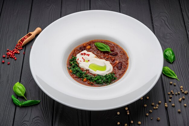 Chili con carne soup on a dark background Mexican food