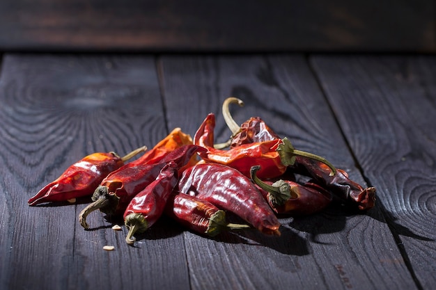 Chili pepper hot red and dried on a dark wooden surface