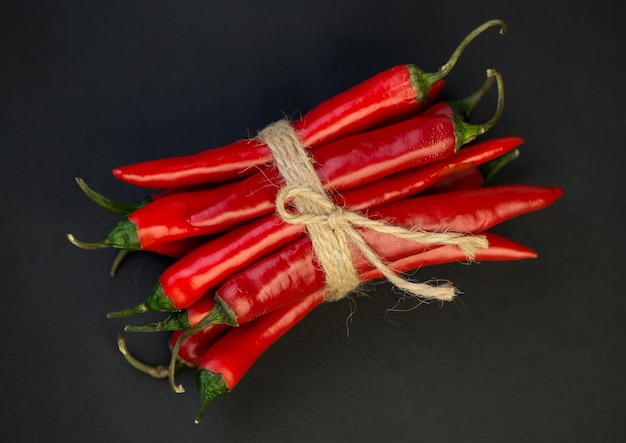 Chili pepper isolated on a black background Knitted hot chili pepper tied with a rope Chili hot pepper clipping path