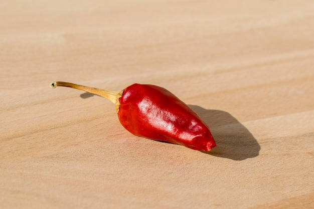 chili pepper isolated on a wooden background