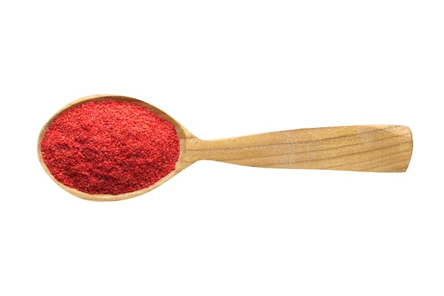 Chili pepper powder for adding to food. spice in wooden spoon isolated on white. seasoning of delicious meal.