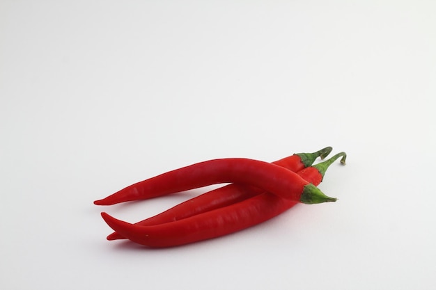 Chili peppers on a white background Fresh chili pepper close up One red pepper on a white