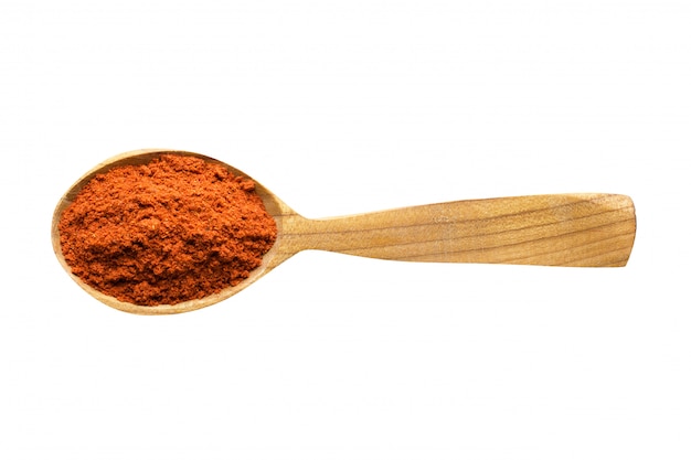 Chili powder in wooden spoon isolated on white background. spice