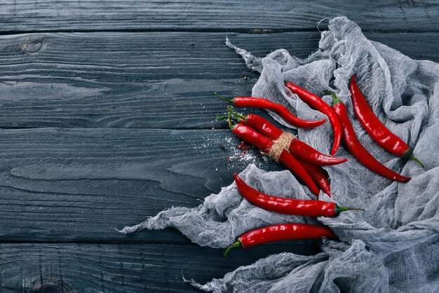 Chili red pepper. On a wooden background. Top view. Free space for your text.