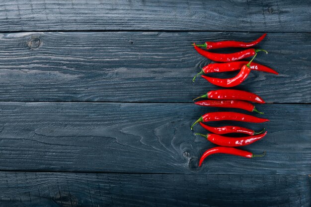 Chili red pepper On a wooden background Top view Free space for your text