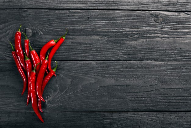 Chili red pepper On a wooden background Top view Free space for your text