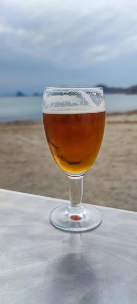 Chilled Beer Glass on a Beachside Table