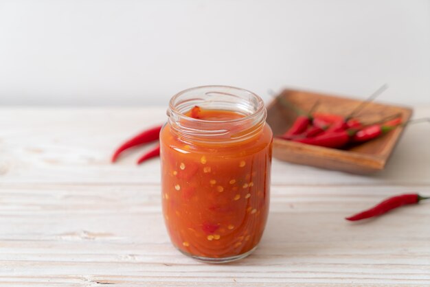 chilli or chilli sauce in bottle and jar on wwod 