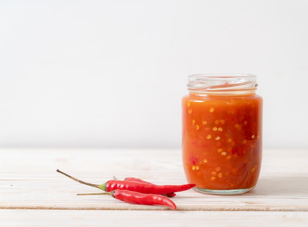 chilli or chilli sauce in bottle and jar on wwod 
