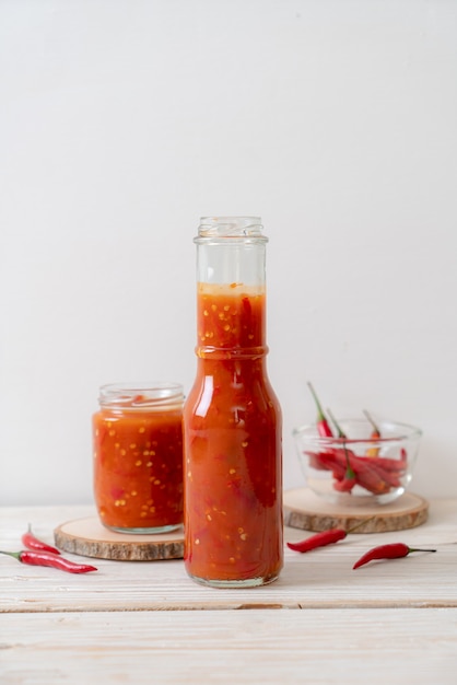 chilli and chilli sauce in glass jars