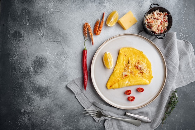 Chilli crab silky omlette , on plate, on gray background, top view flat lay  , with copyspace  and space for text