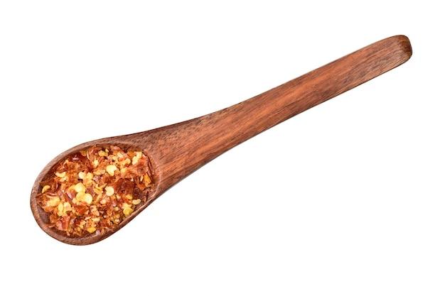 Chilli flakes in wooden spoon isolated on white background with clipping path