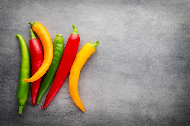 Chilli pepper on the grey surface.