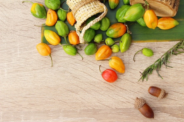 Chilli peppers for cooking on wood background