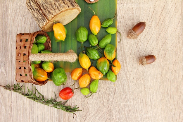 chilli peppers for cooking on wood background